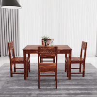Wooden dining table set with four chairs side view