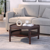 Wooden coffee table with decorative items in front of a gray sofa.