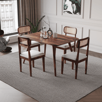 Dining room with wooden table and chairs on a gray rug