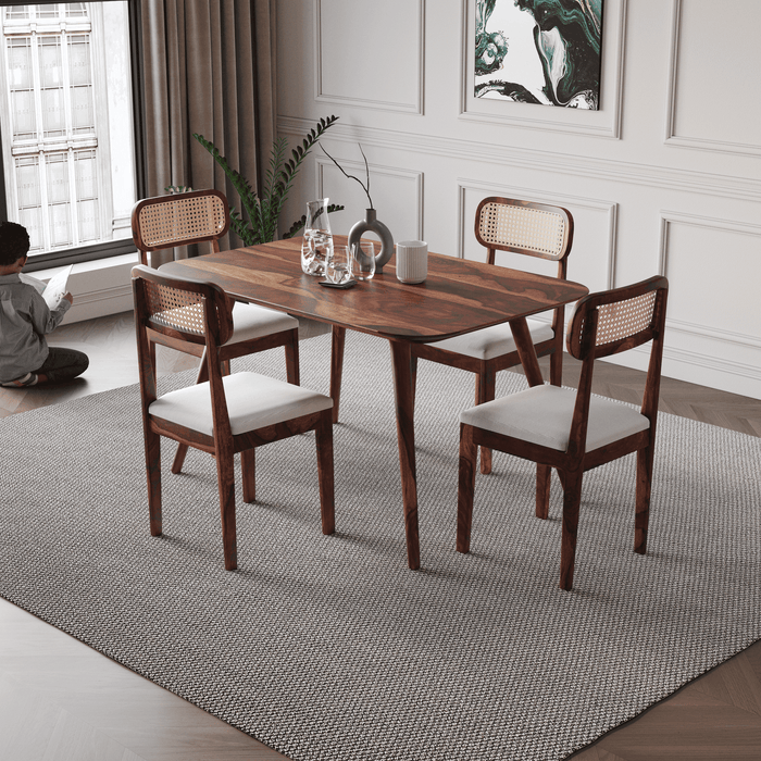 Dining room with wooden table and chairs on a gray rug