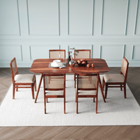 Dining table set with chairs in a room with paneled walls.