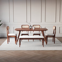 Dining room set with wooden table and chairs on a light rug.