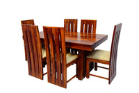Wooden dining table set with six chairs on a white background