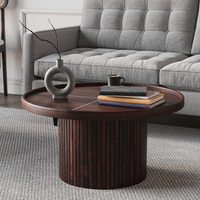 Wooden coffee table with decorative items in a living room setting