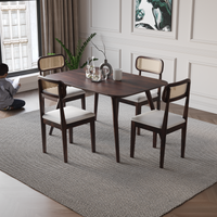 Dining room with wooden table and chairs on a gray rug