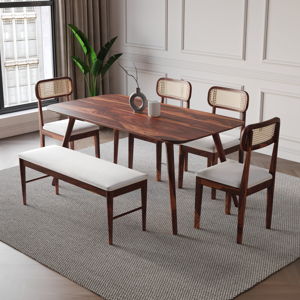 Dining room set with wooden table and chairs on a gray rug.