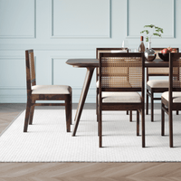 Dining table with four chairs in a room side chair view