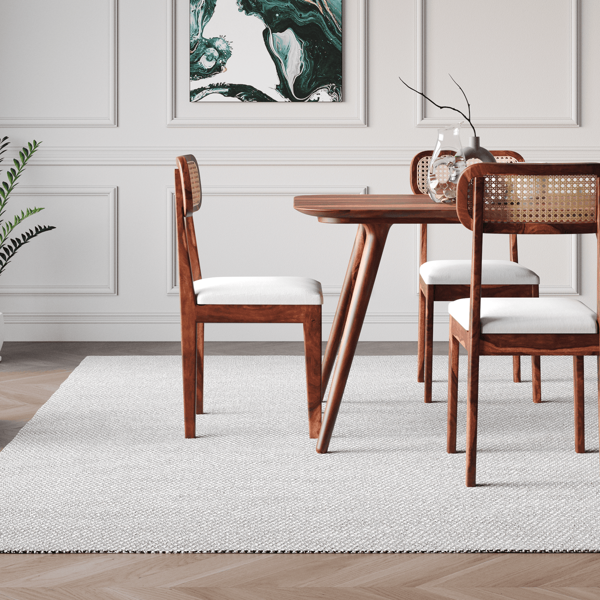 Dining room with wooden table and chairs on a light gray rug.