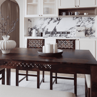 Dining area with a wooden table and chairs in a modern kitchen.