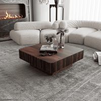 Modern living room with a sectional sofa, wooden coffee table, and fireplace.