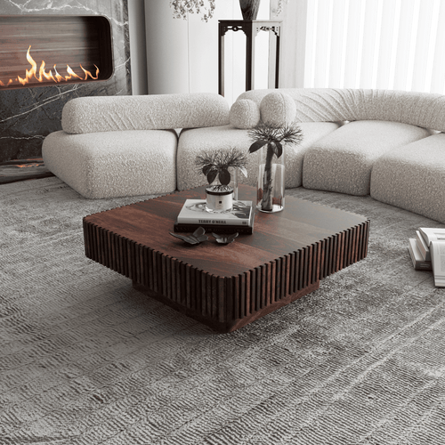 Modern living room with a sectional sofa, wooden coffee table, and fireplace.