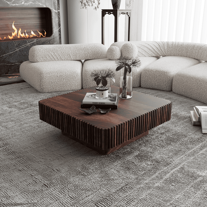 Modern living room with a sectional sofa, wooden coffee table, and fireplace.