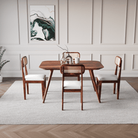 Dining room with wooden table and chairs in a modern interior setting.