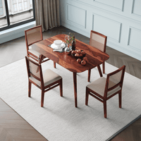 Wooden dining table with four chairs in a room side upper view