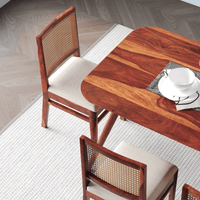 Wooden dining table with chairs on a tiled floor