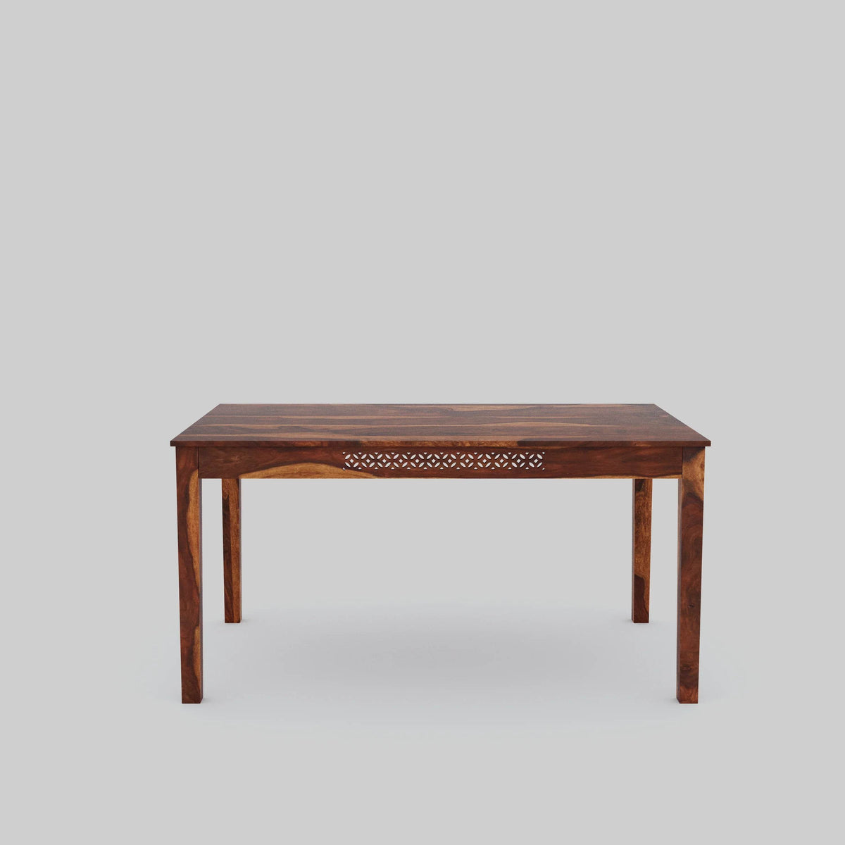 Wooden table with intricate carvings on a gray background